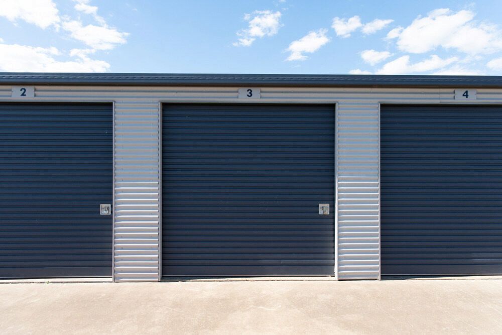 Exterior of Three Storage Units With Dark Blue Doors — The Bay Self Storage In Urangan, QLD
