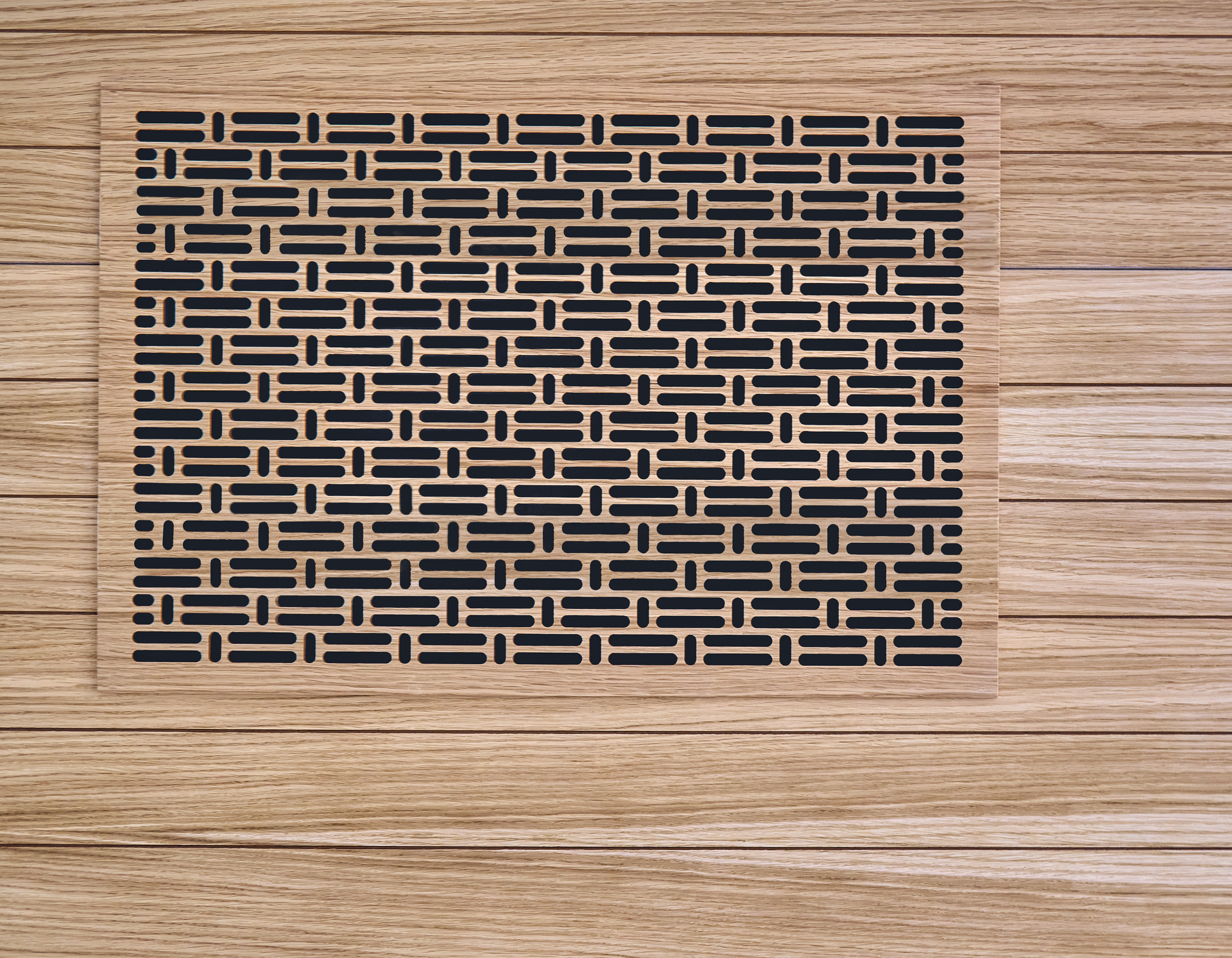 A wooden wall with a grille on it that looks like a brick wall.