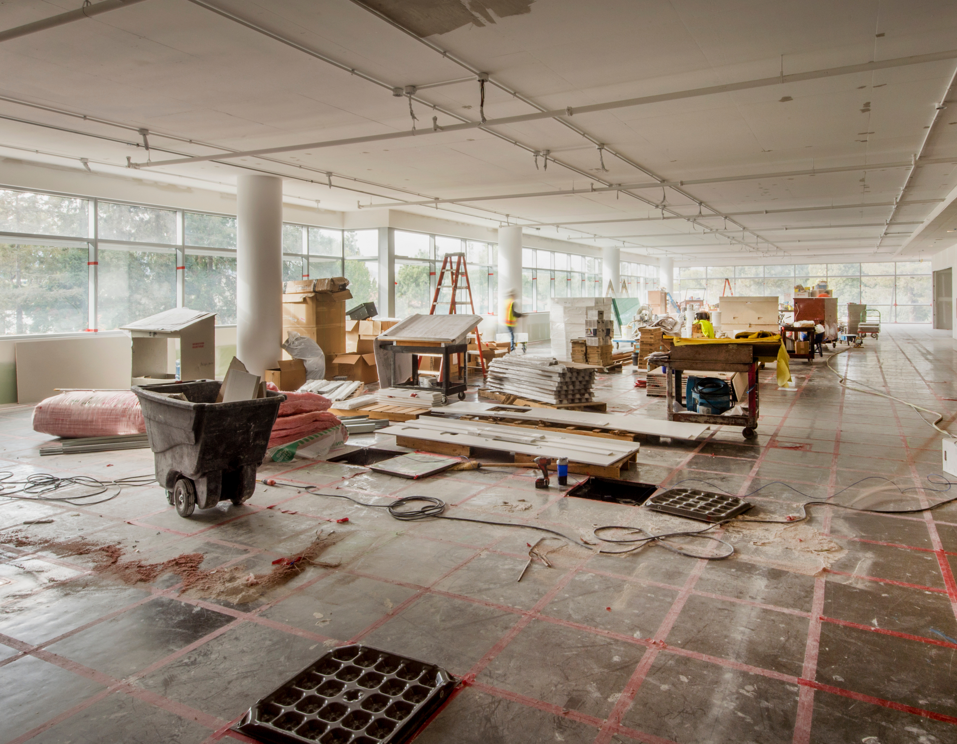 A large room with a lot of furniture and a wheelbarrow on the floor.