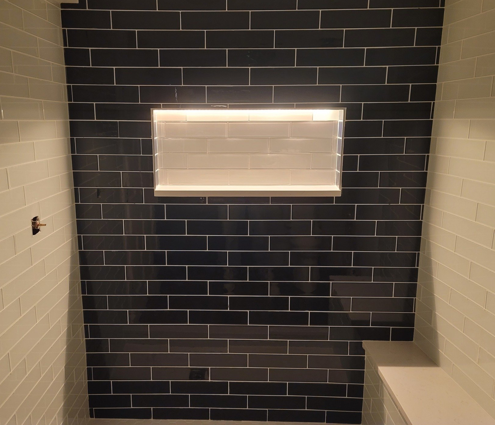 Bathroom with white shower and toilet, wood-look floor tiles, white vanity, and light blue walls.
