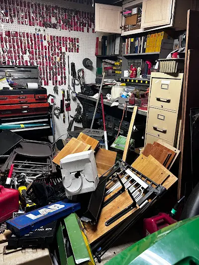 A garage filled with lots of junk and tools.