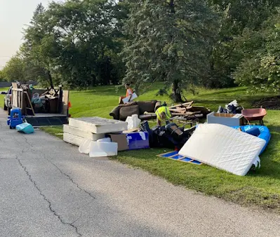 A pile of junk is sitting on the side of a road.