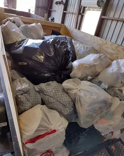 A pile of trash bags sitting on top of a wooden box.