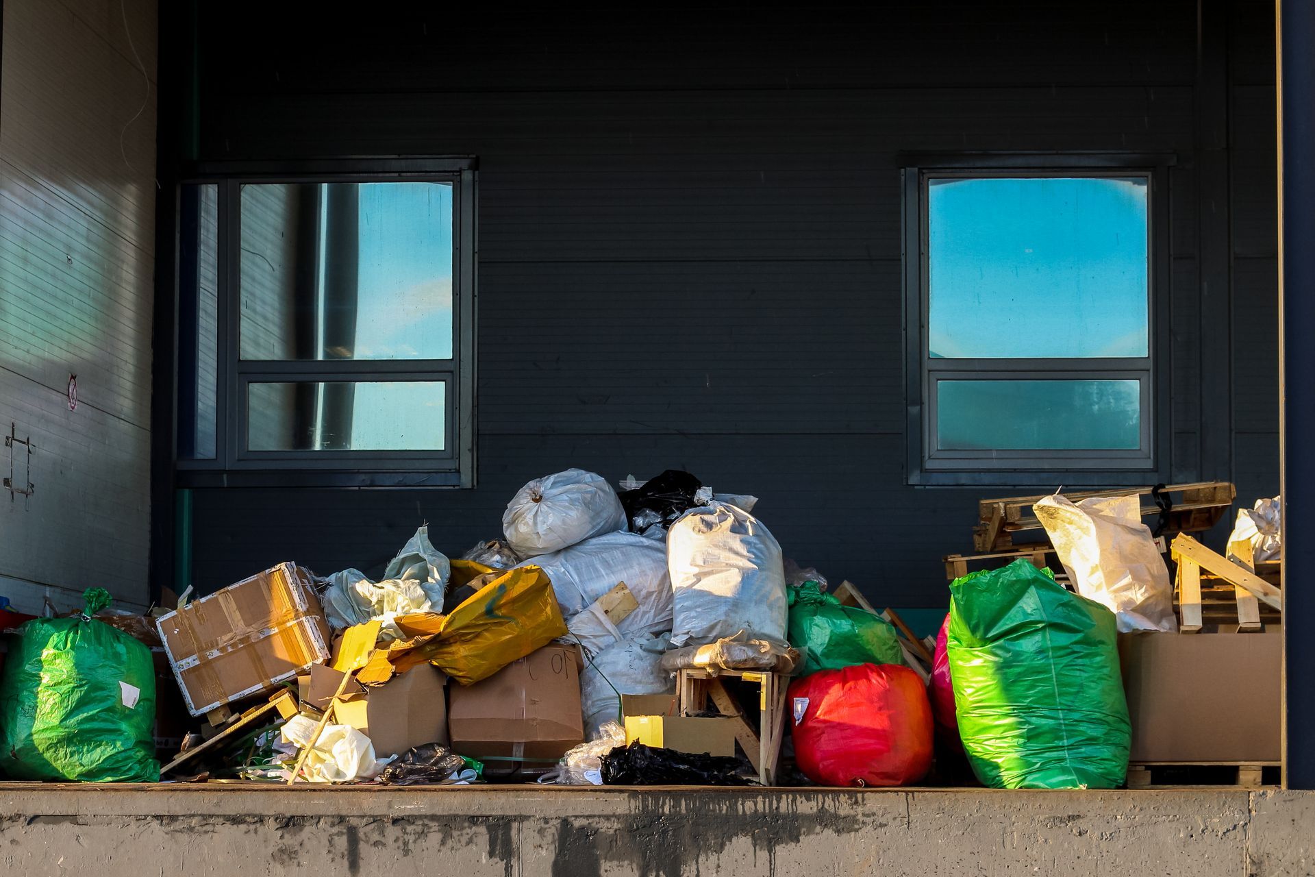 A pile of trash is sitting in front of a building.