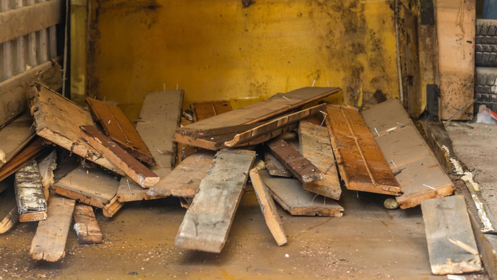 A pile of wood is sitting in a yellow bin.