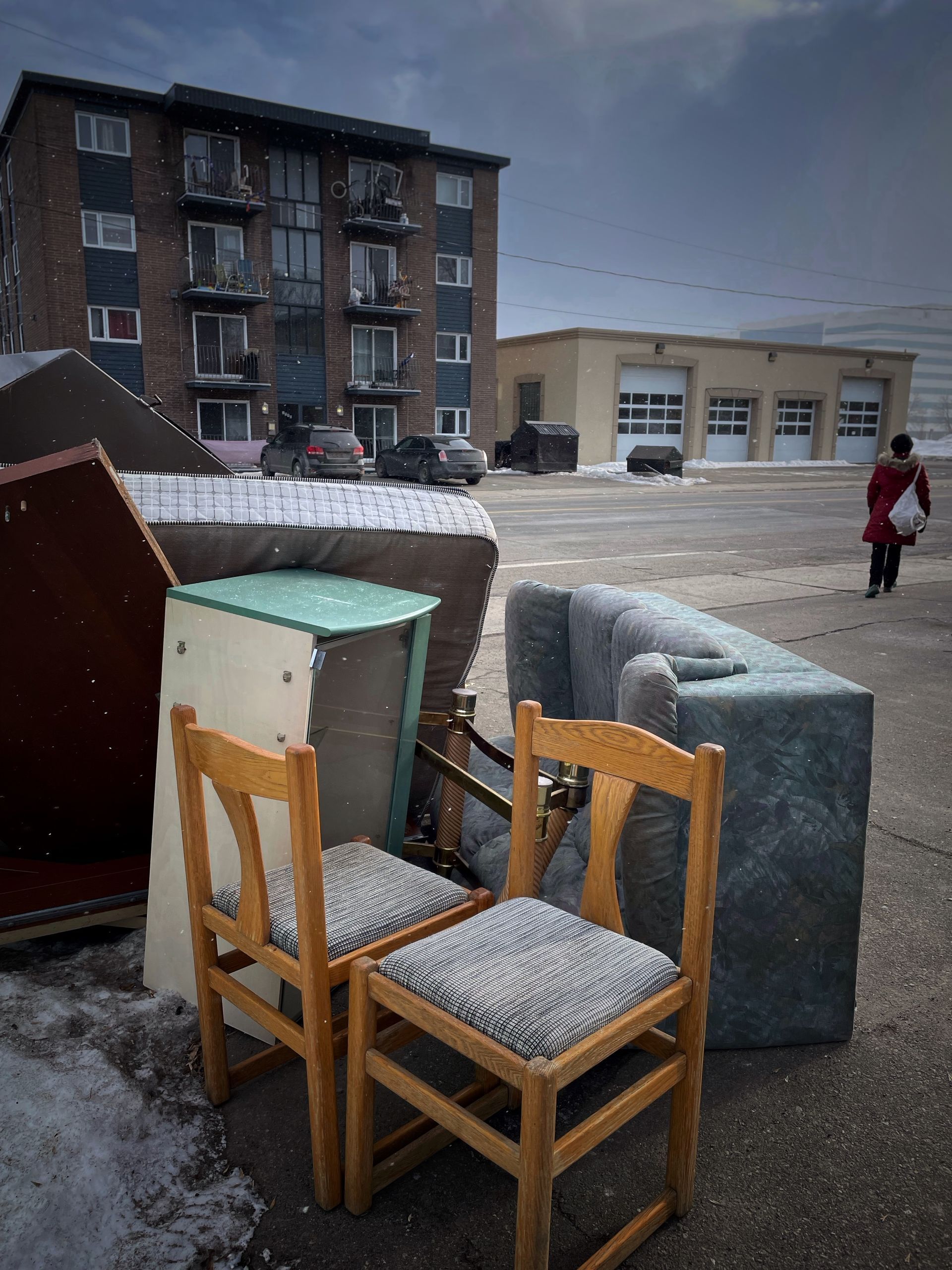 A couple of chairs and a couch in front of a building