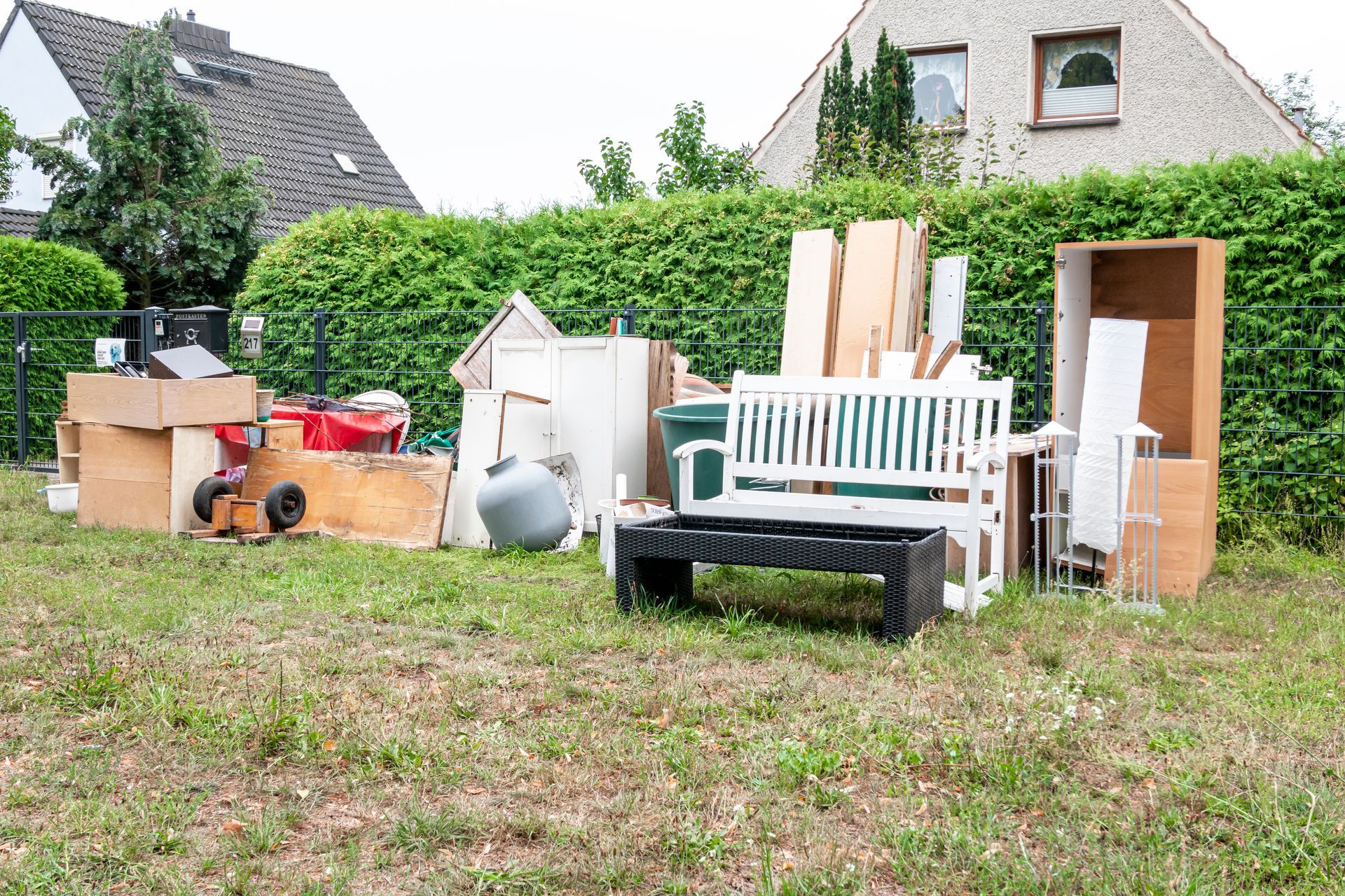 A bunch of junk is sitting on top of a lush green field.