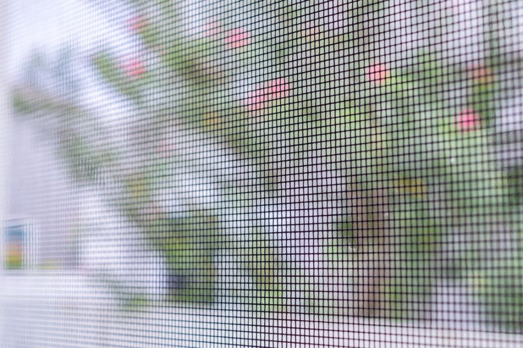 A car is parked on the side of the road next to a pile of junk