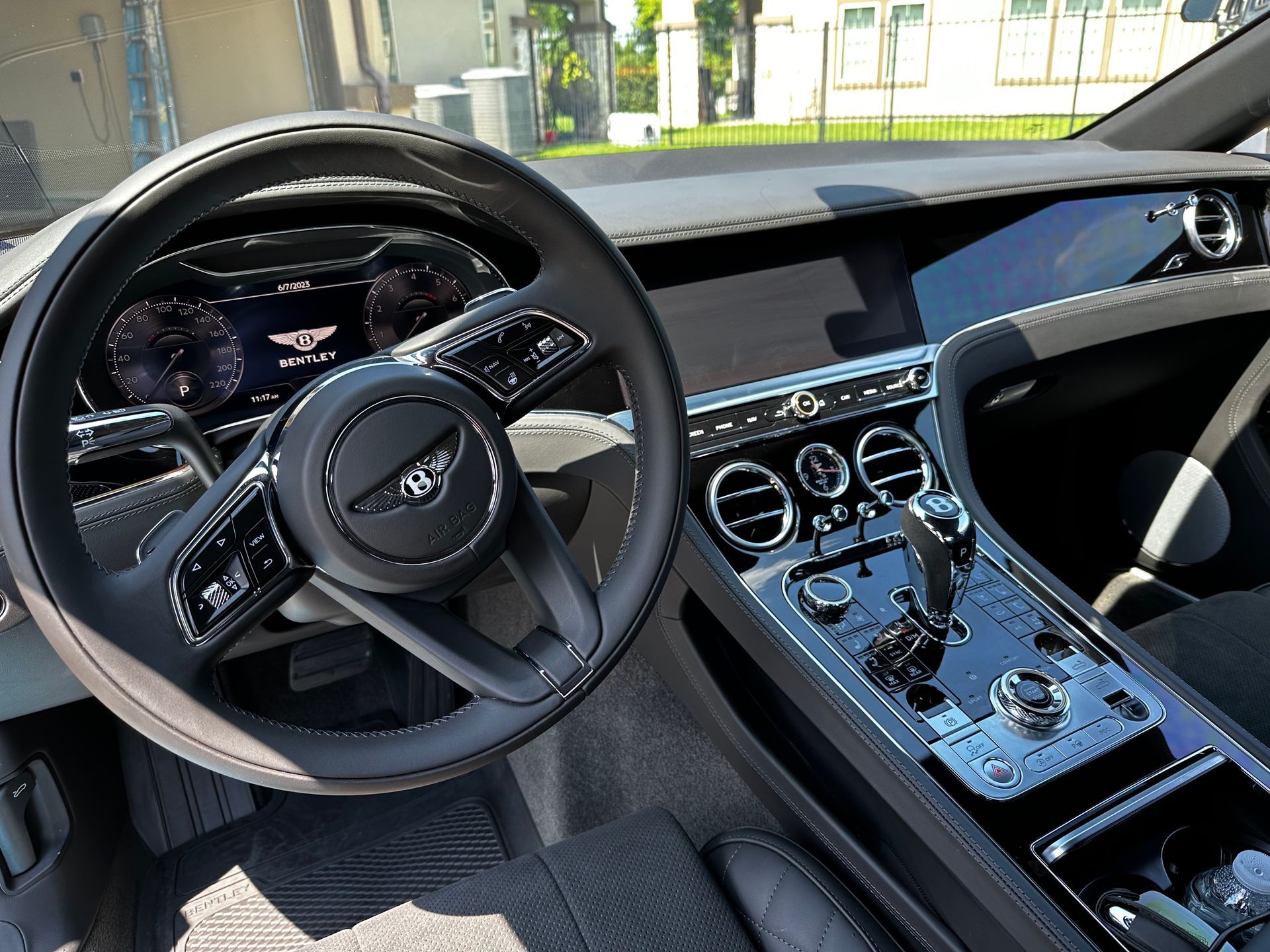 The interior of a bentley car with a steering wheel
