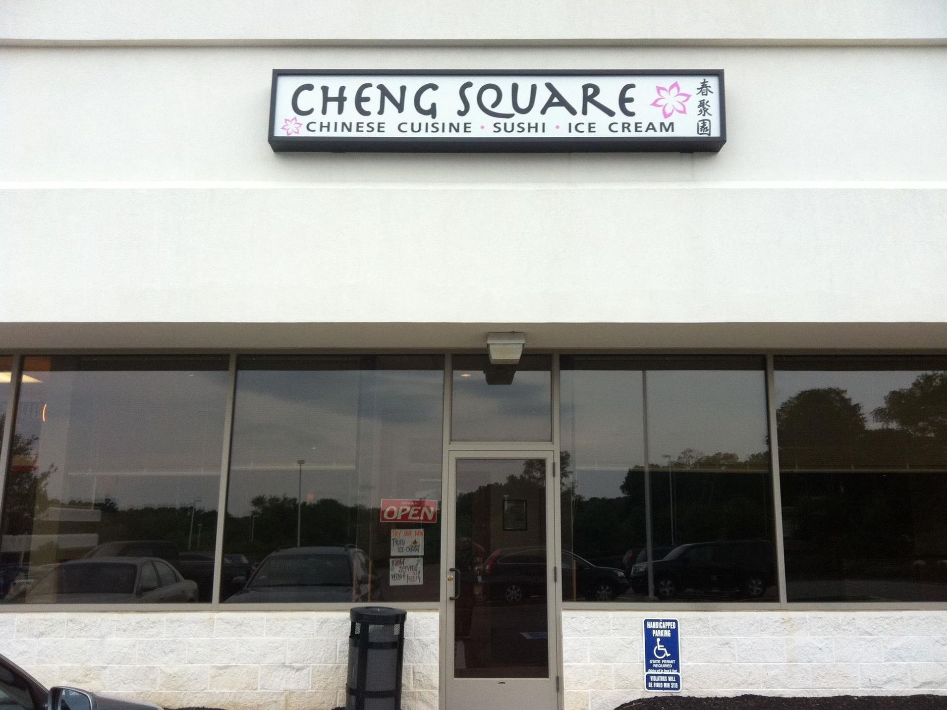 A white building with a sign that says cheng square