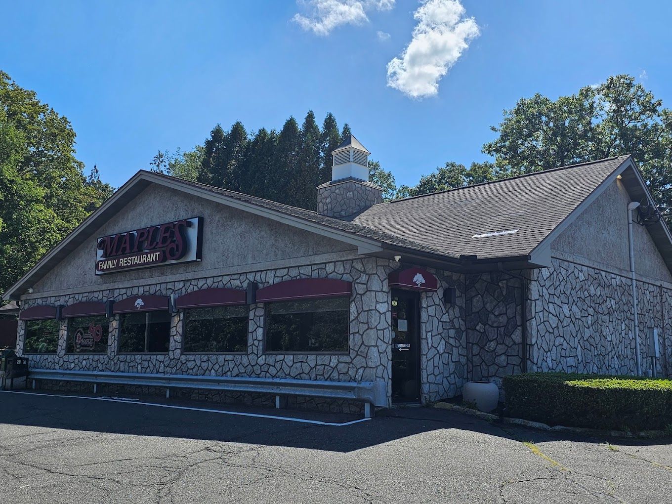 A large stone building with a sign that says 'maples' on it