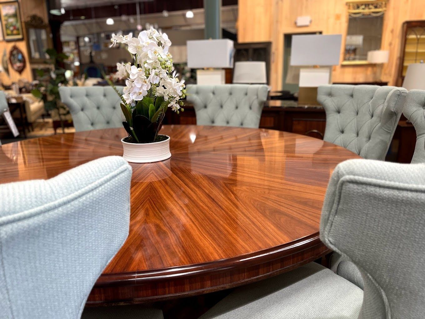 A wooden table with a vase of flowers on it