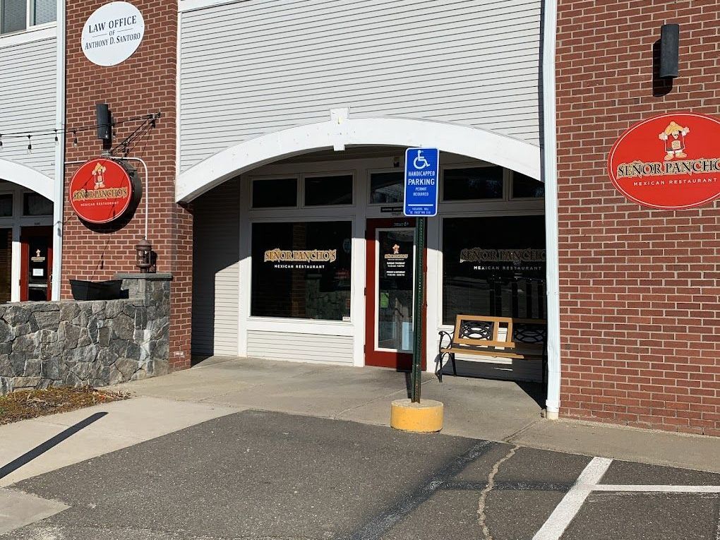 A brick building with a handicapped parking spot in front of it