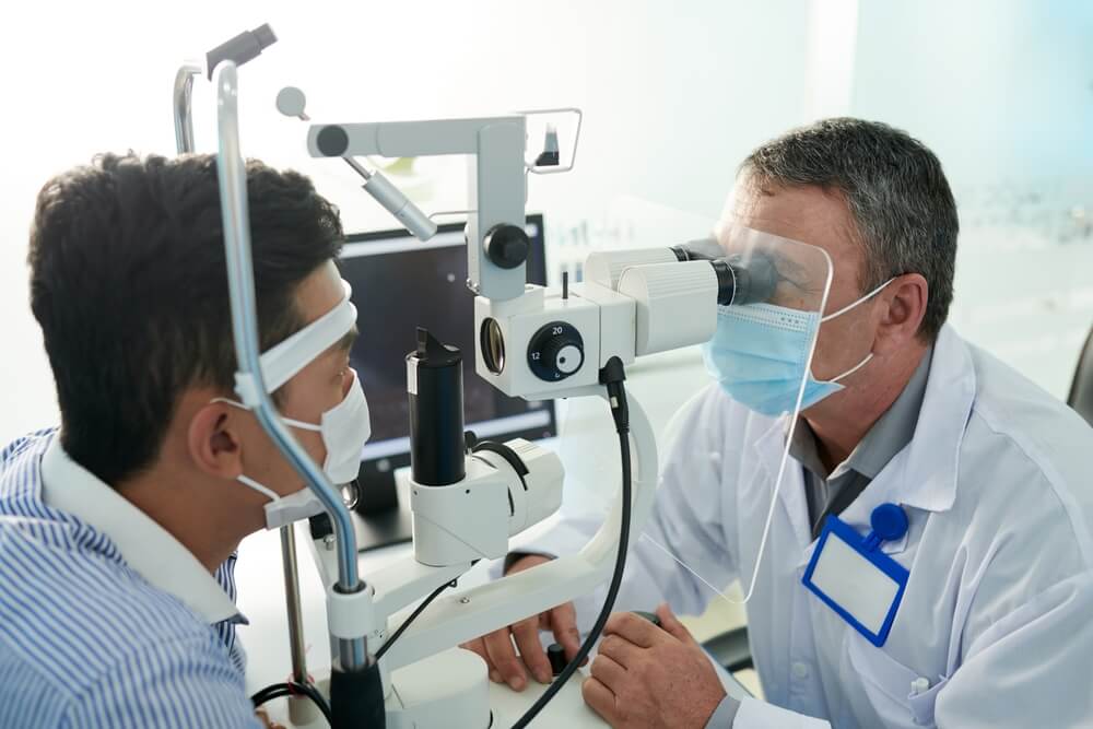 Optometrist Checking Patient's Eye — Your Ophthalmologist in Townsville, QLD