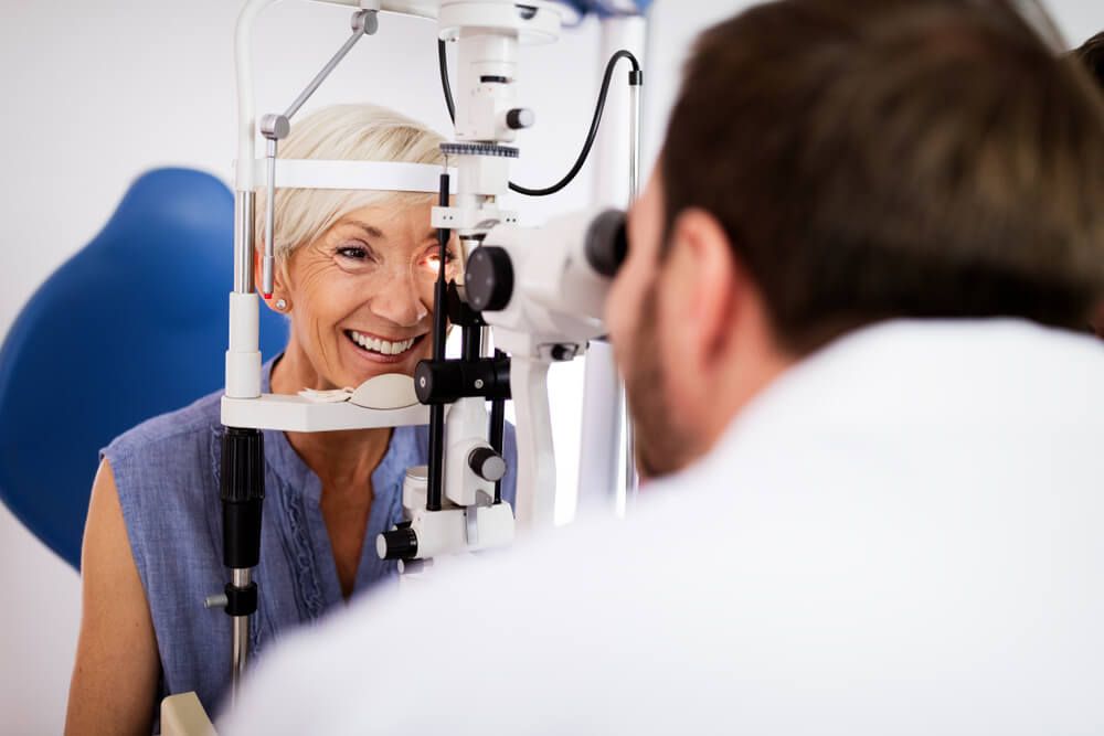 Optometrist Examining Woman's Eyes — Your Ophthalmologist in Townsville, QLD