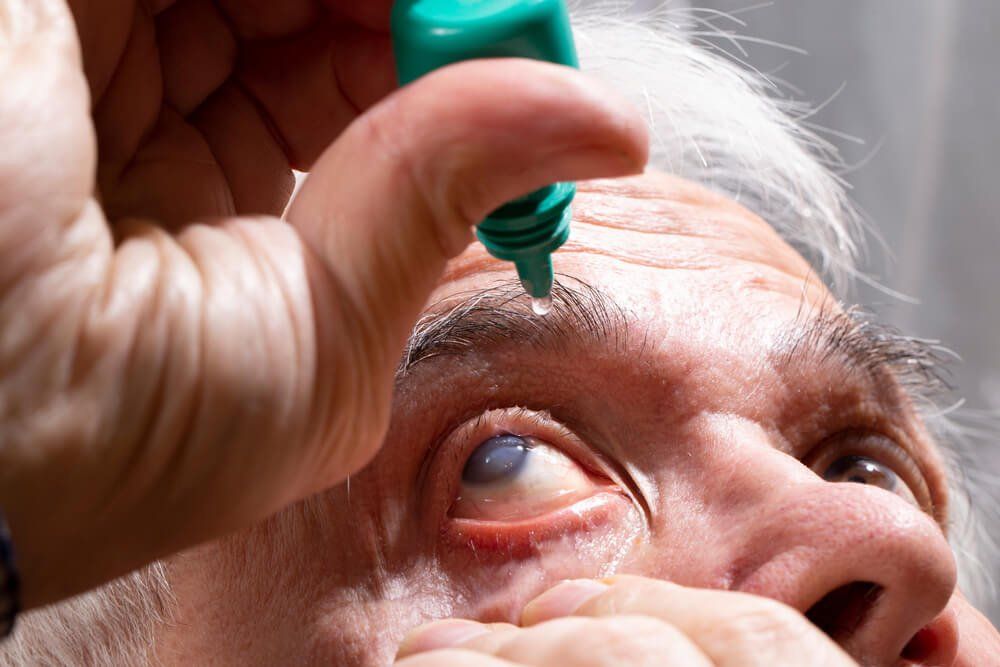 Man Using Eye Drops — Your Ophthalmologist in Townsville, QLD