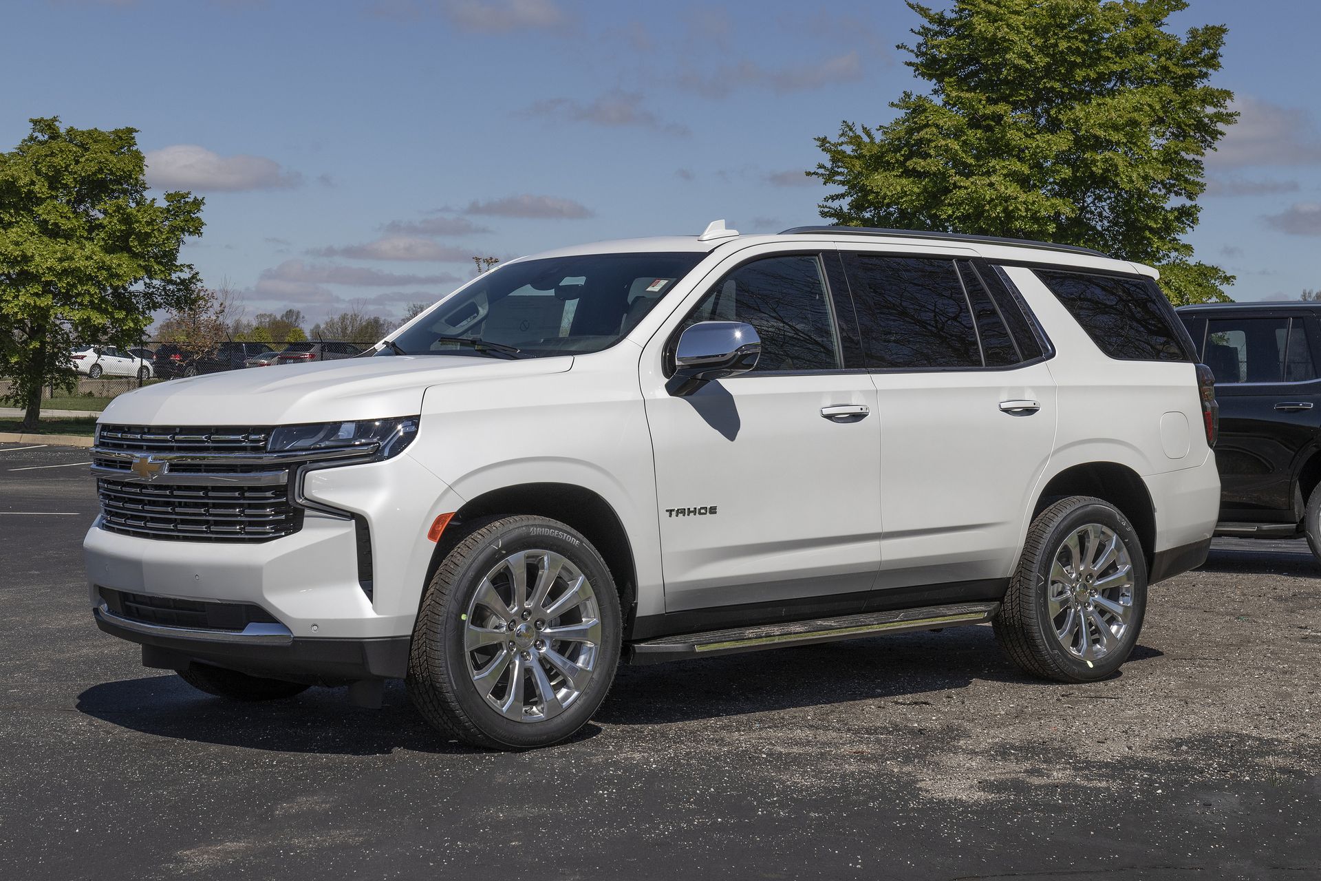 White Chevrolet Tahoe SUV parked on asphalt.