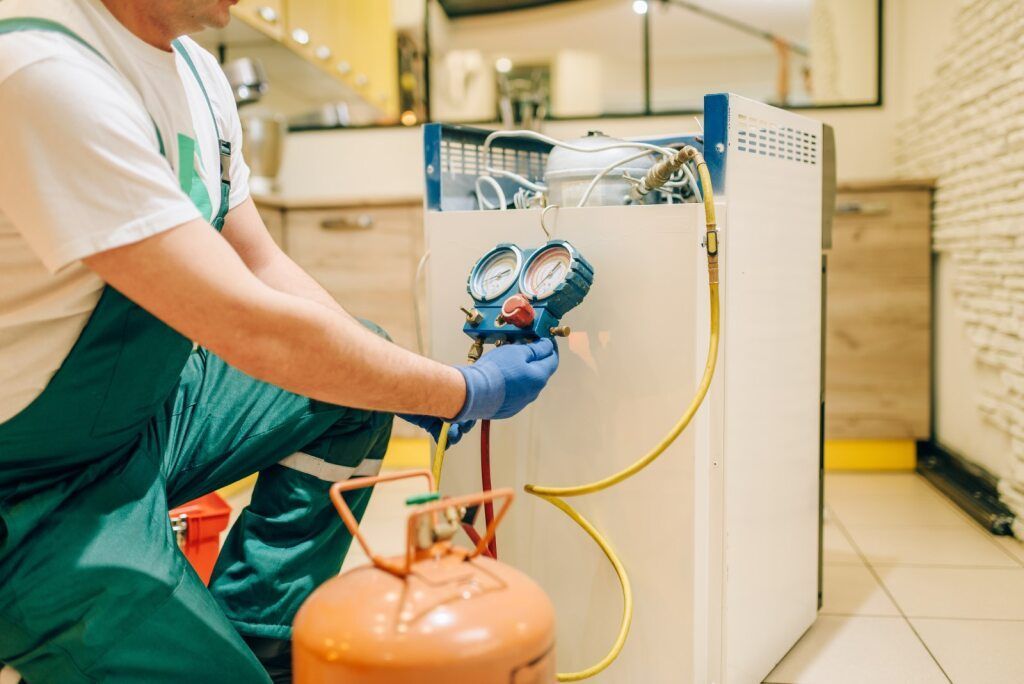 HVAC Technician Repairs a Refrigerator — Brownlow Electrical Air Conditioning Refrigeration In Fairy Meadow, NSW