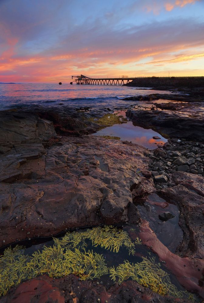 Sunset Over a Rocky Coast — Brownlow Electrical Air Conditioning Refrigeration In Shellharbour, NSW