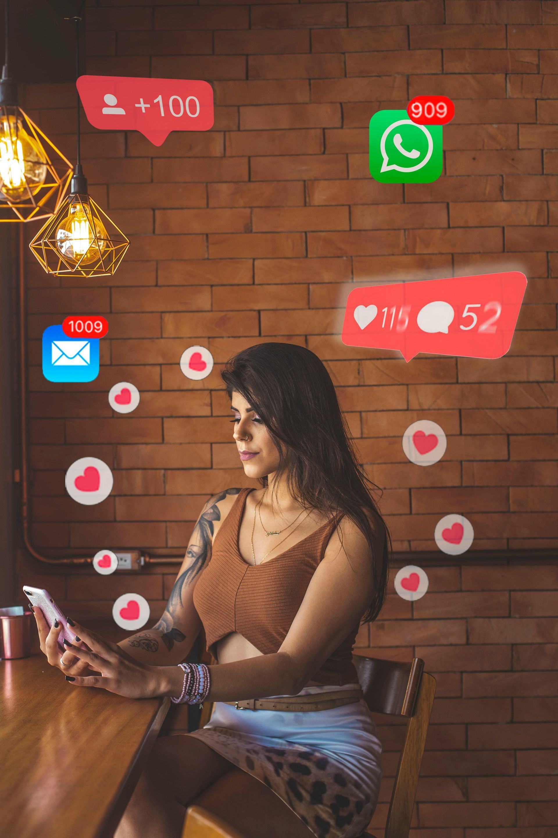 A woman is sitting at a table looking at her phone.