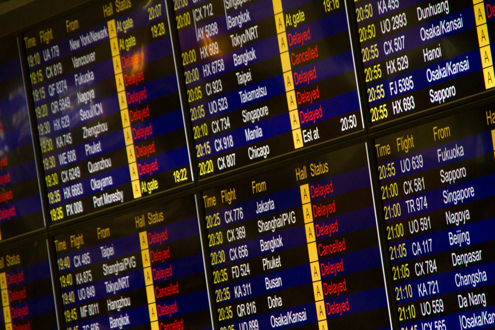 A large screen displays a list of flights and their times