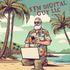 A man with a beard is kneeling on the beach with a laptop and a cell phone.