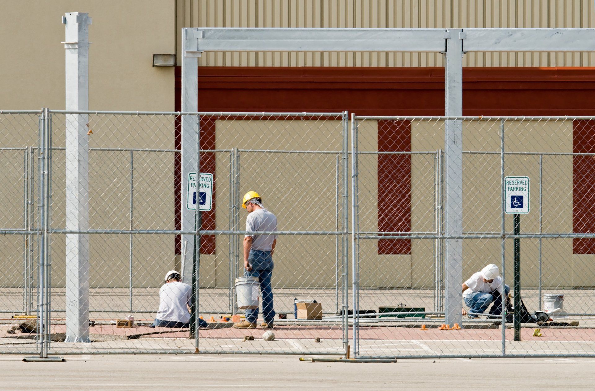 Worker Installing Chain Link Fence — Mobile, AL — Mobile Fence