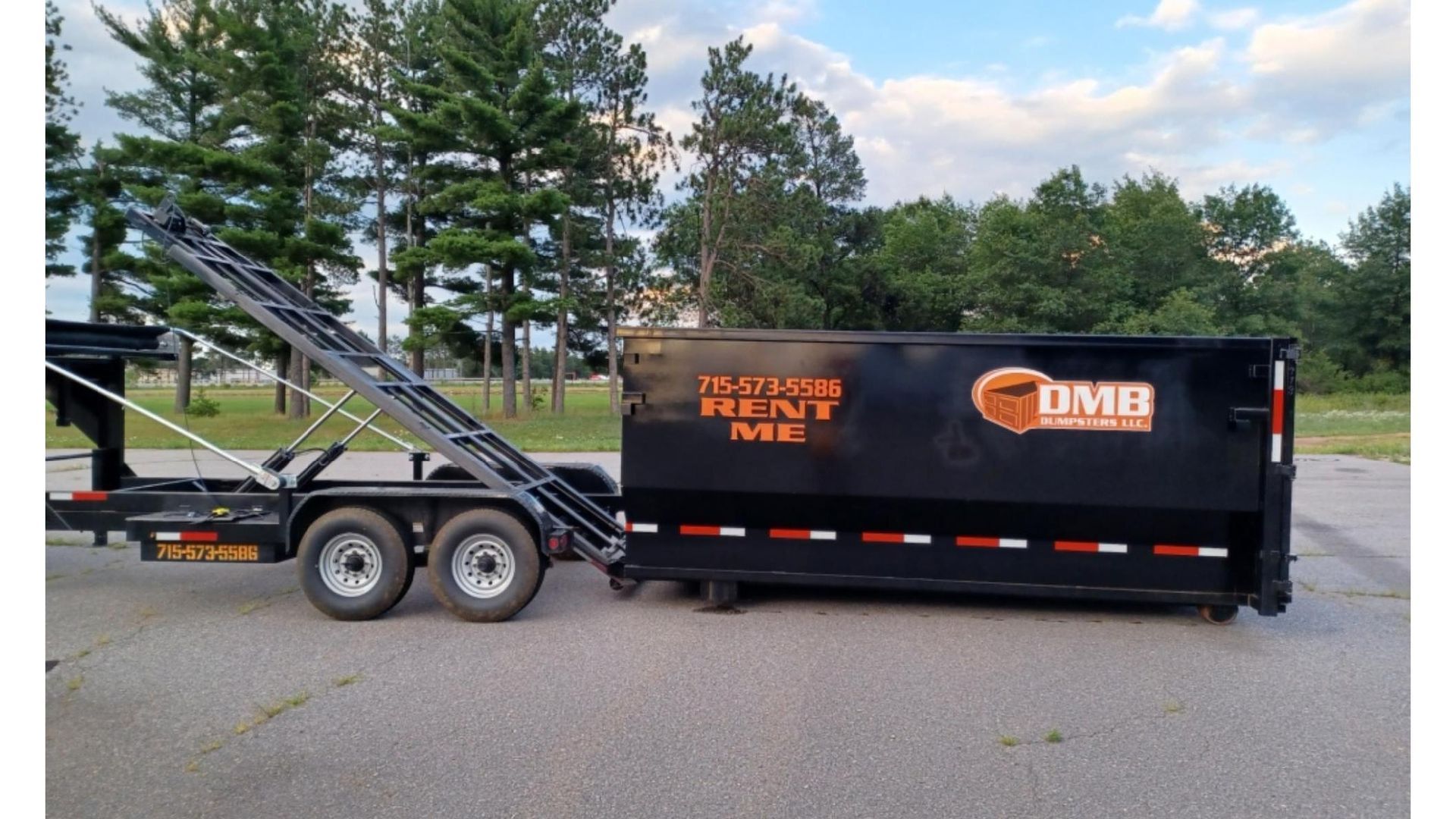 A dumpster on a trailer that says umb on it