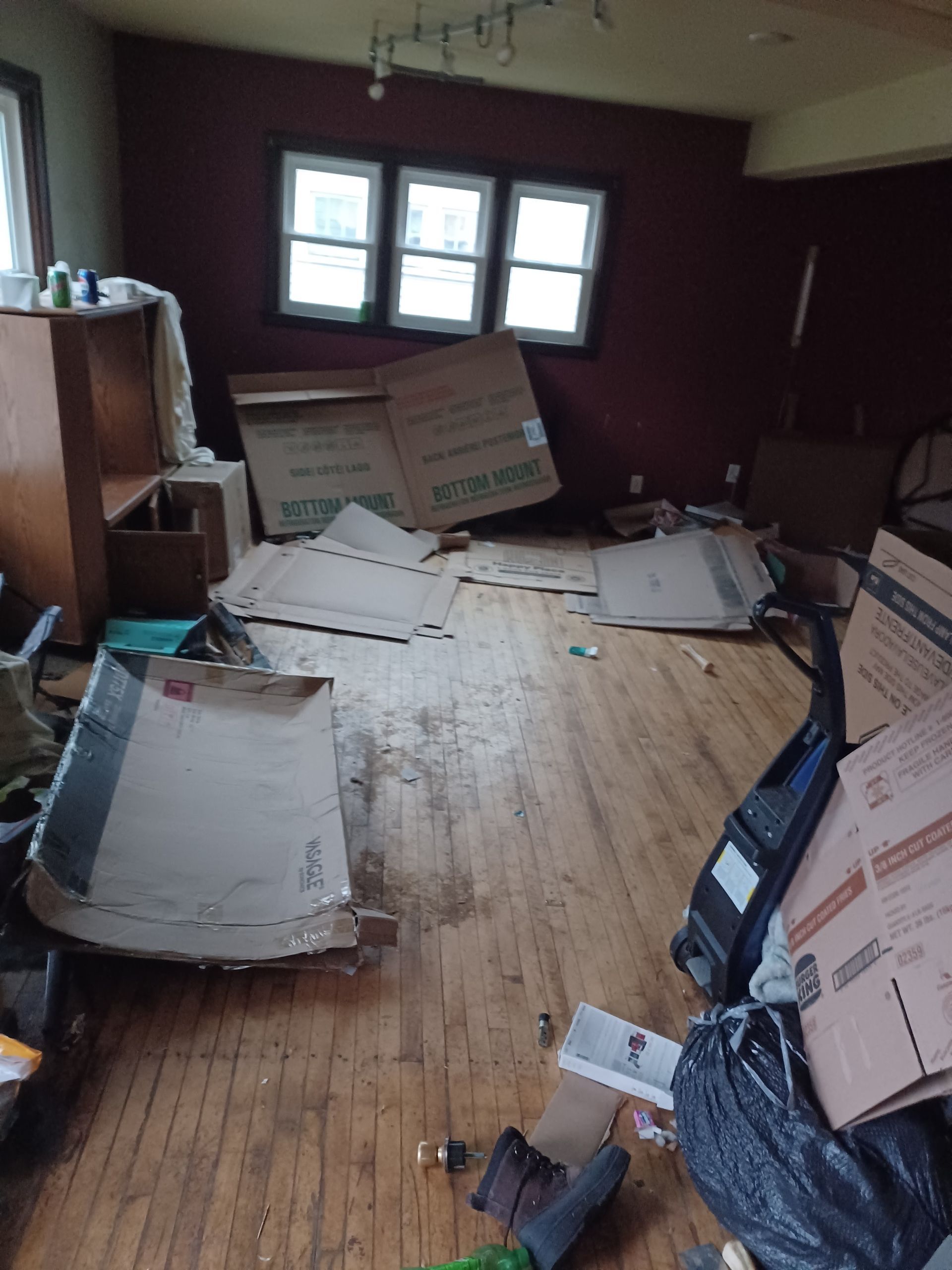 A room with a lot of cardboard boxes on the floor