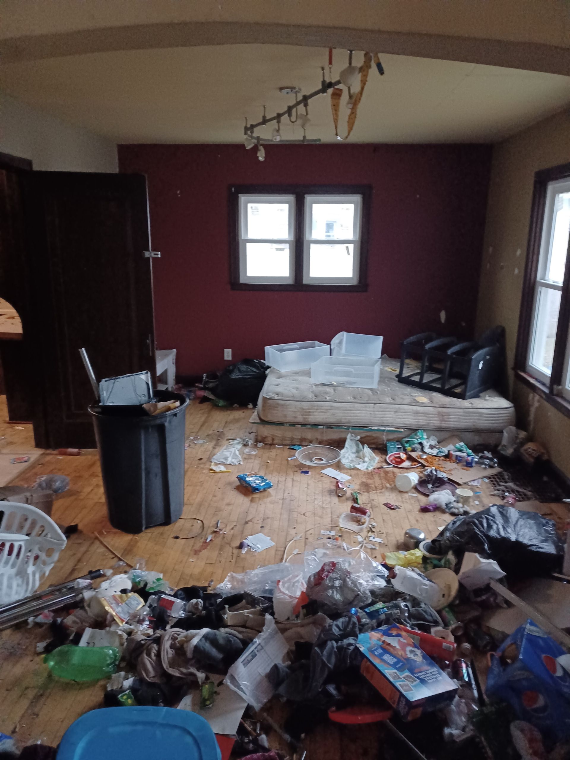 A messy room with a mattress on the floor