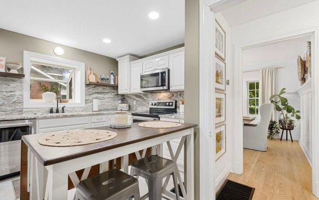 A kitchen with wooden cabinets and stainless steel appliances