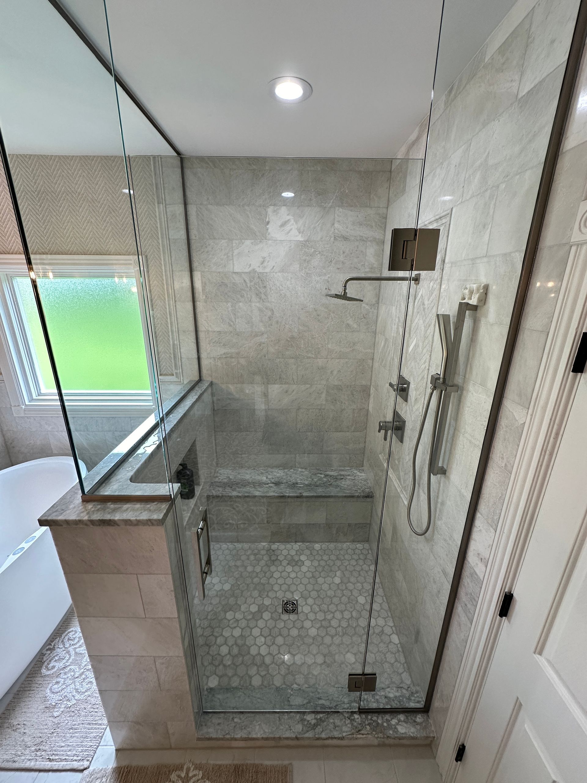 A bathroom with a walk in shower and a toilet