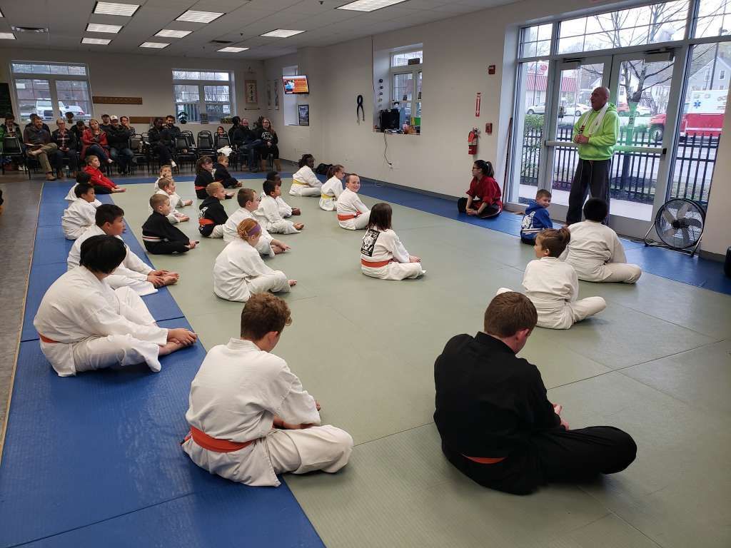 kids sitting in martial arts class