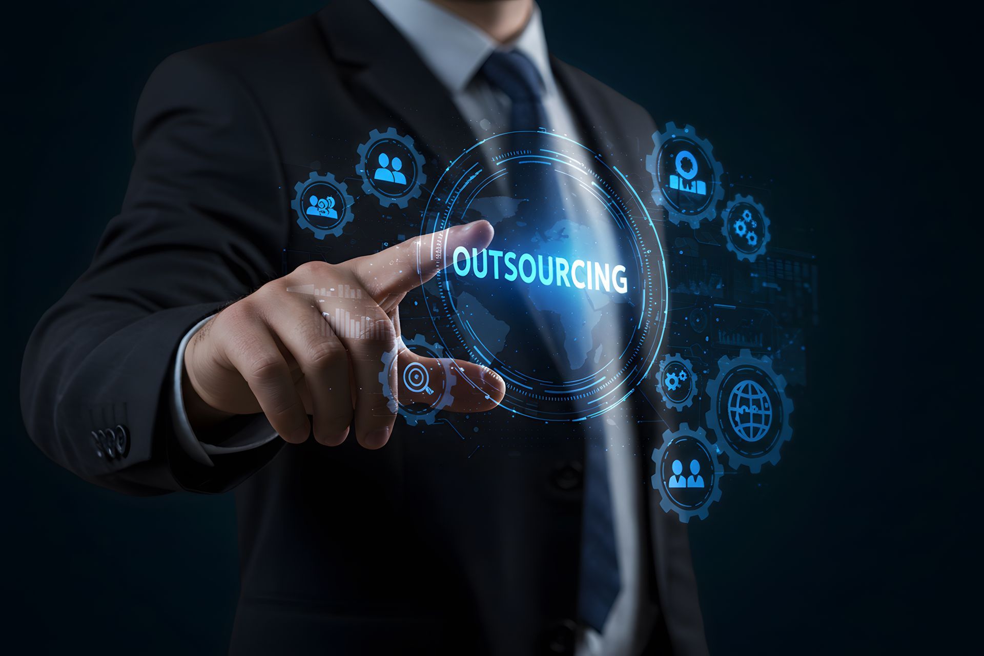 A man in a suit and tie is pointing at a screen that says outsourcing.