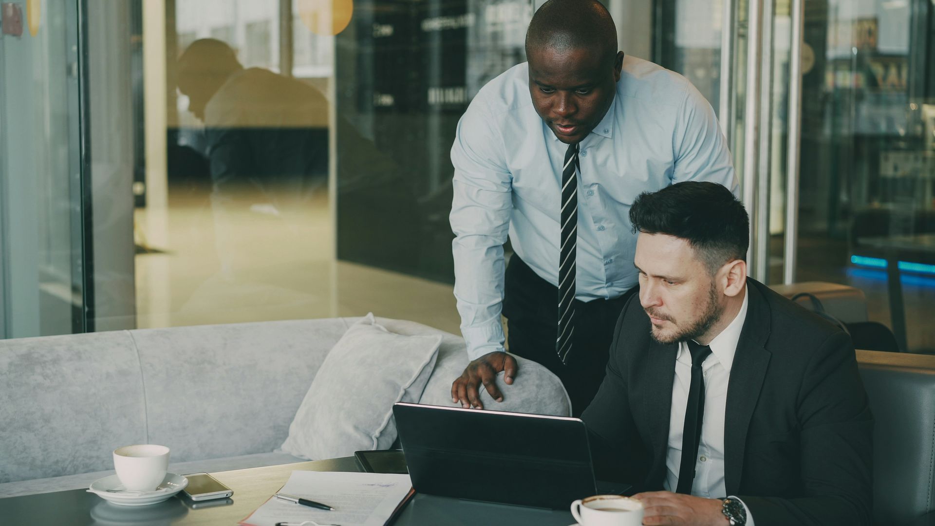 California business owner looking concerned while reviewing paperwork in an office setting.