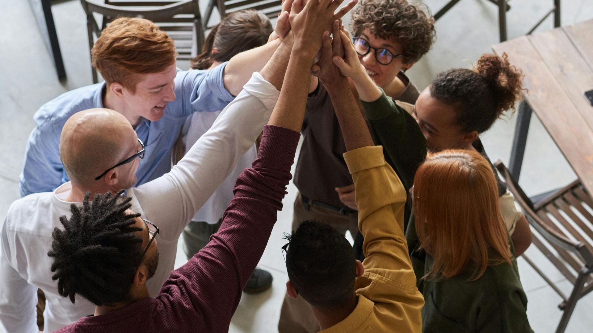 A group of people are giving each other a high five.