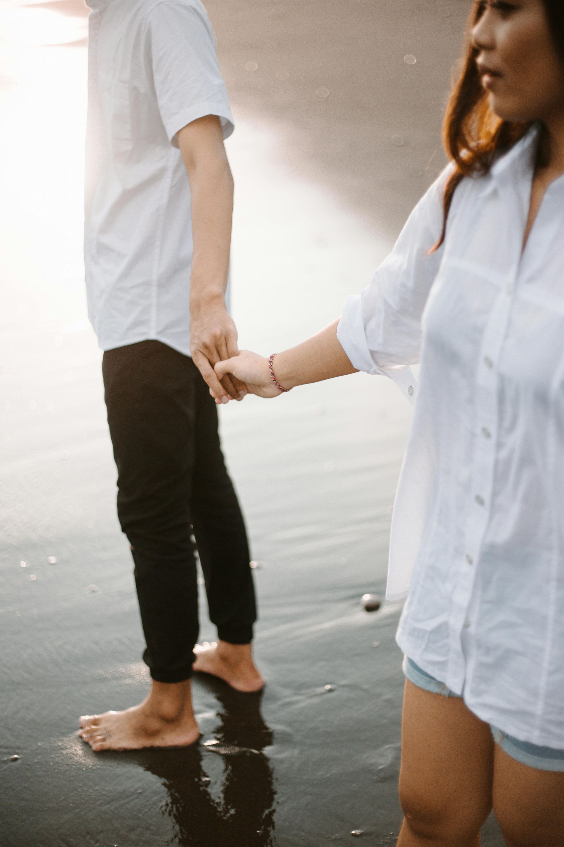 Couple Holding Hands on a Couch, in a Therapy Session — Mind Guidance Centre in Wangi Wangi, NSW
