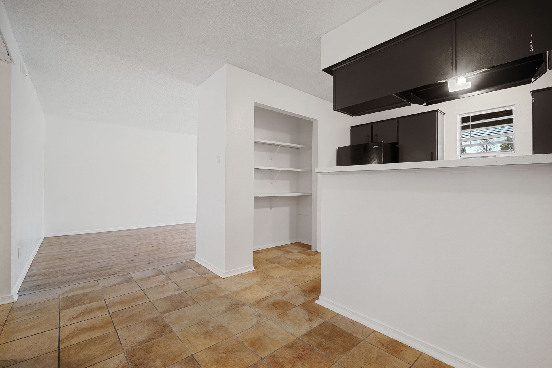 Photo showing a kitchen entrance with built in shelves