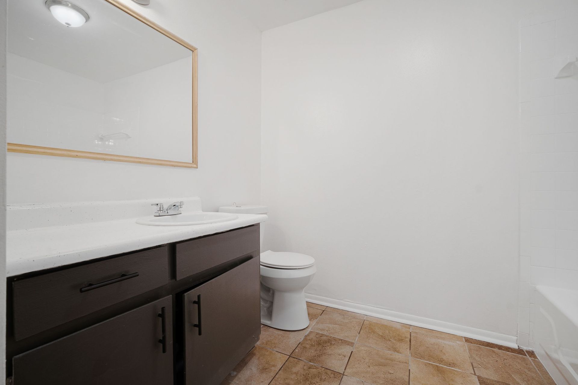 Bathroom photo showing wide mirror and sink