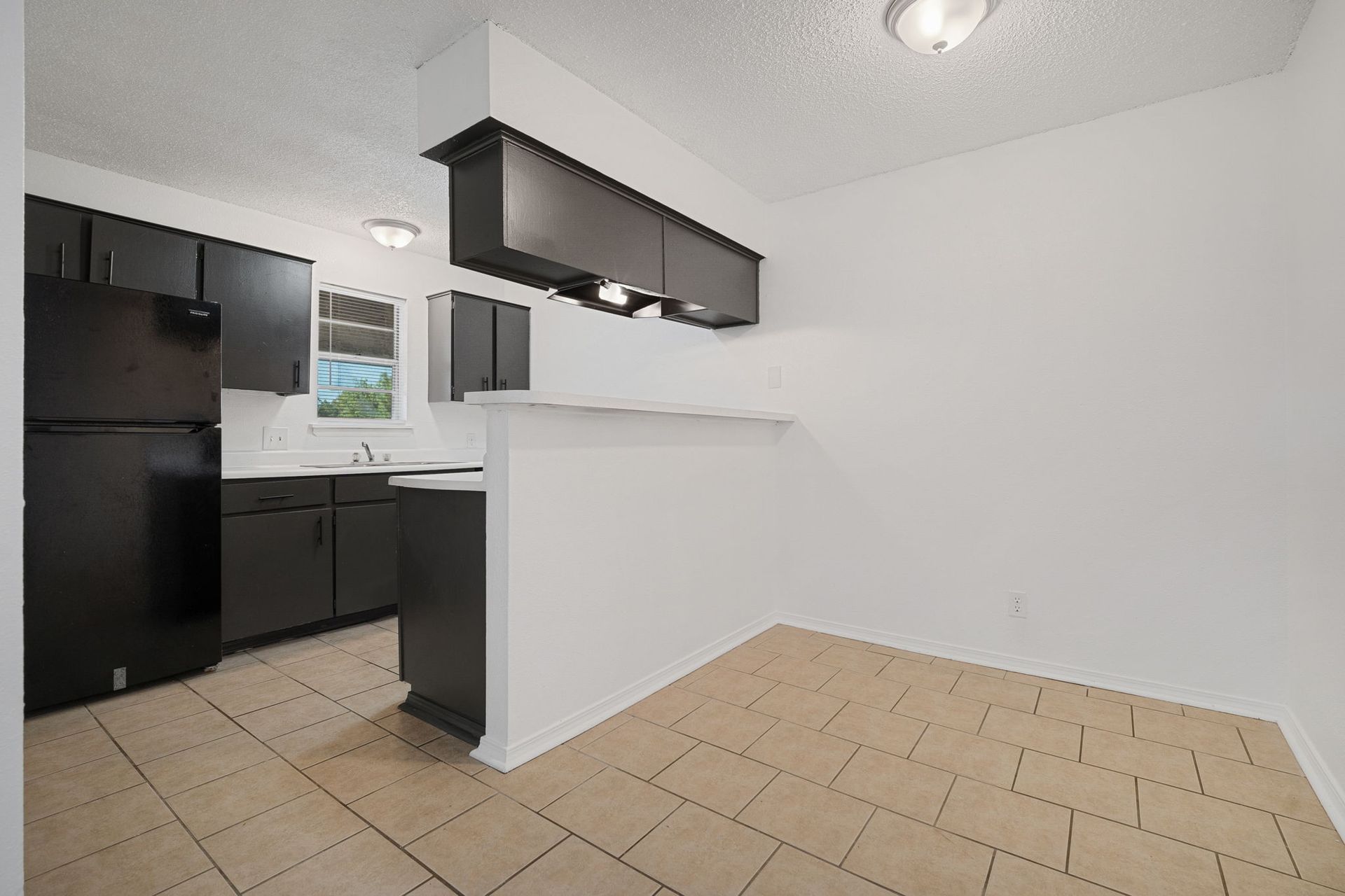 Photo showing the entrance to the kitchen with an area potentially for barstools