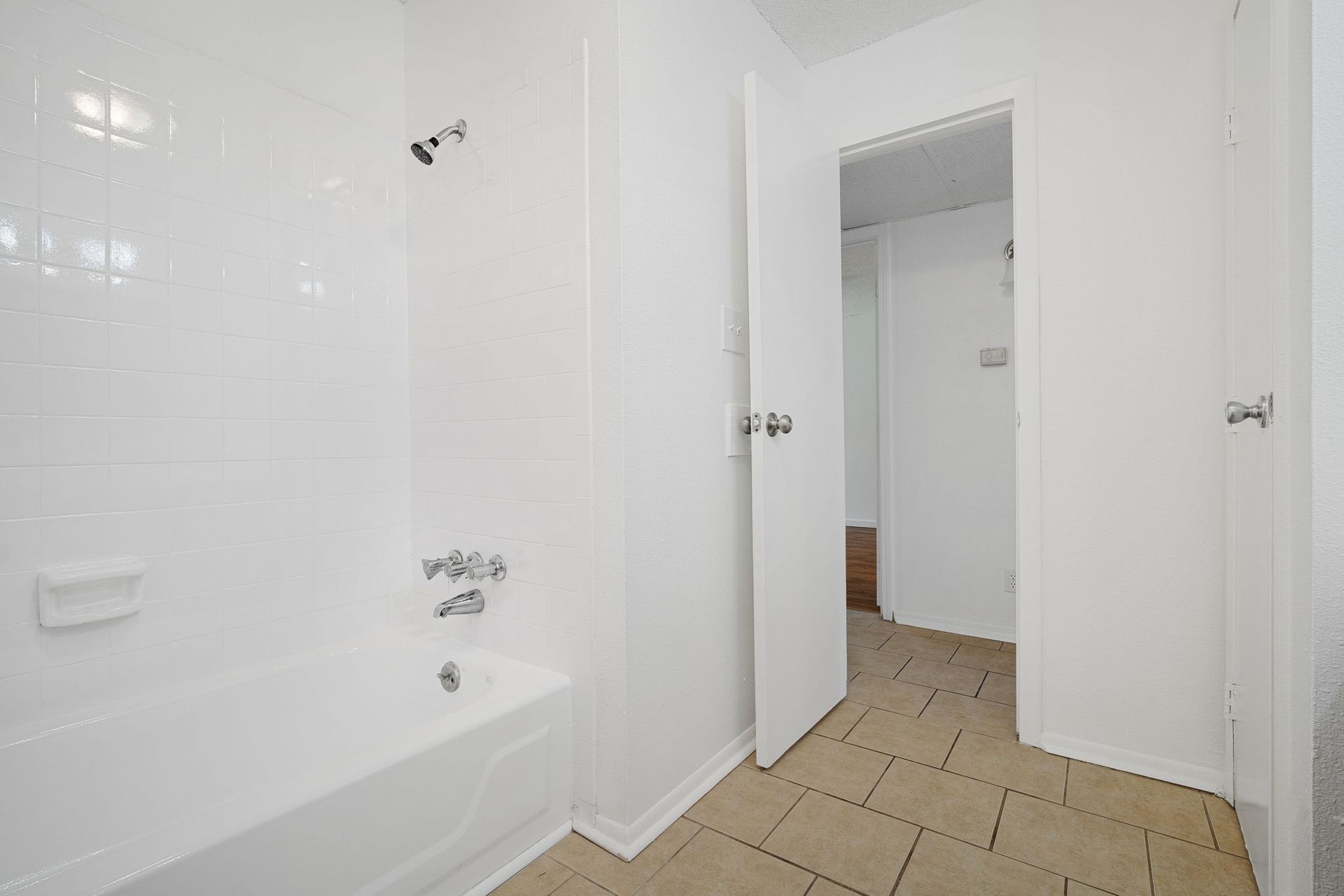 Photo showing bathtub and the entrance to the bathroom