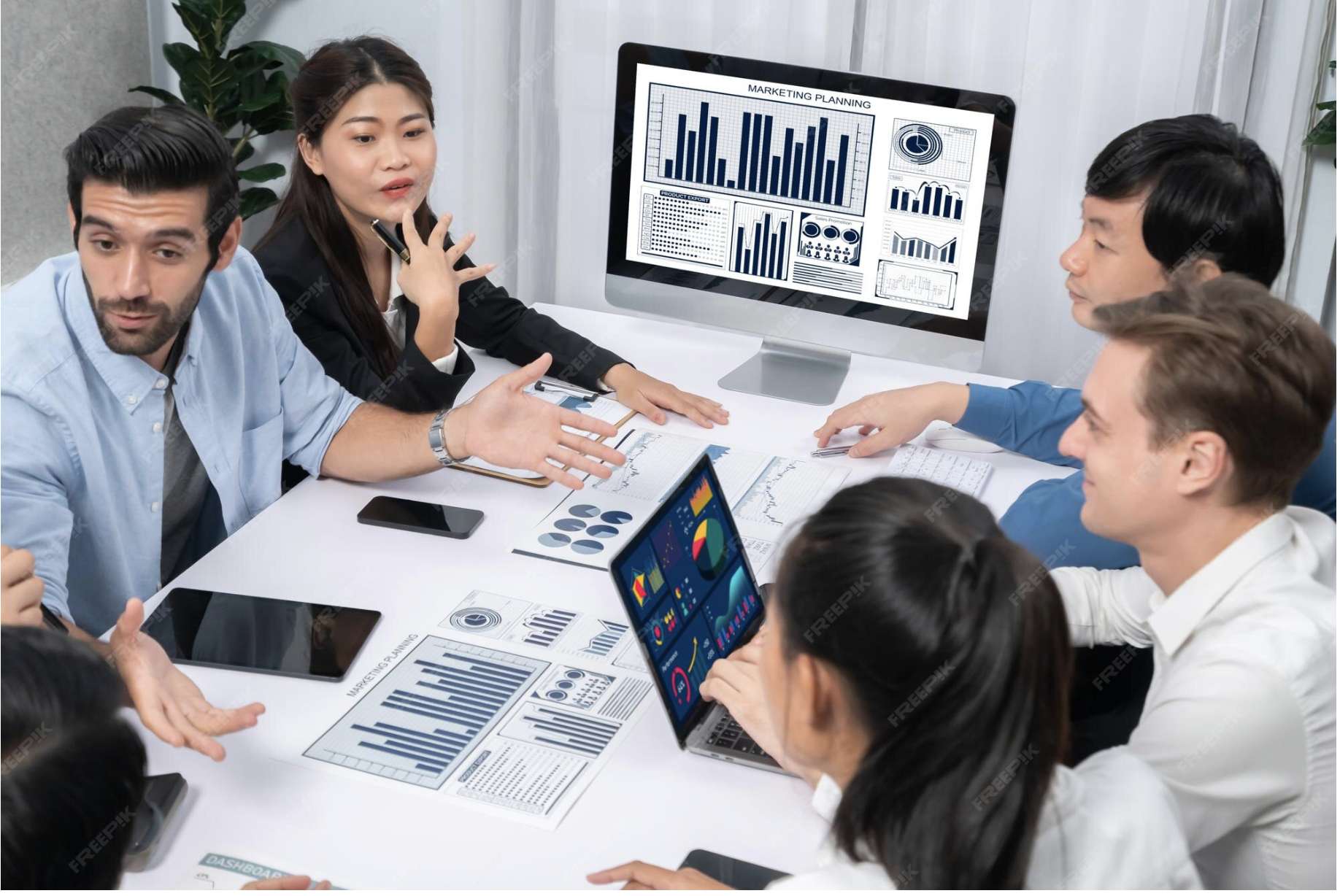 HR leaders reviewing employee engagement data and survey insights during a team meeting using employee survey software analytics.
