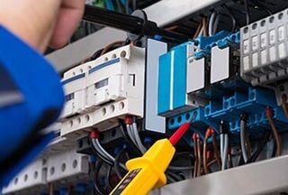 Electrician Checking Fusebox — Caprock Electric Inc in Lubbock, TX