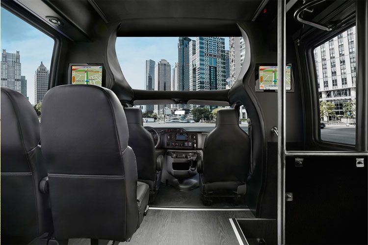 The inside of a bus with a city in the background.
