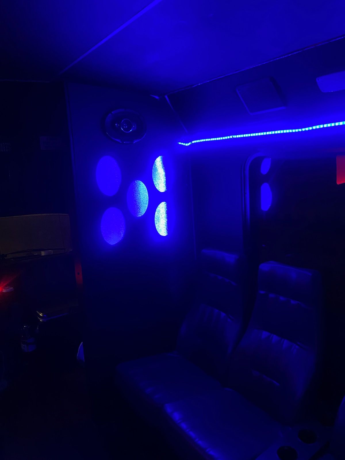 A dark room with blue lights on the ceiling.