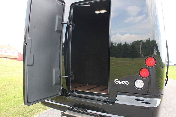The back of a black van with the door open.
