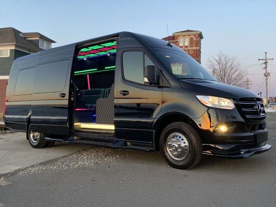 A black van is parked on the side of the road with its doors open. Frisco TX Blue Ribbon Limo