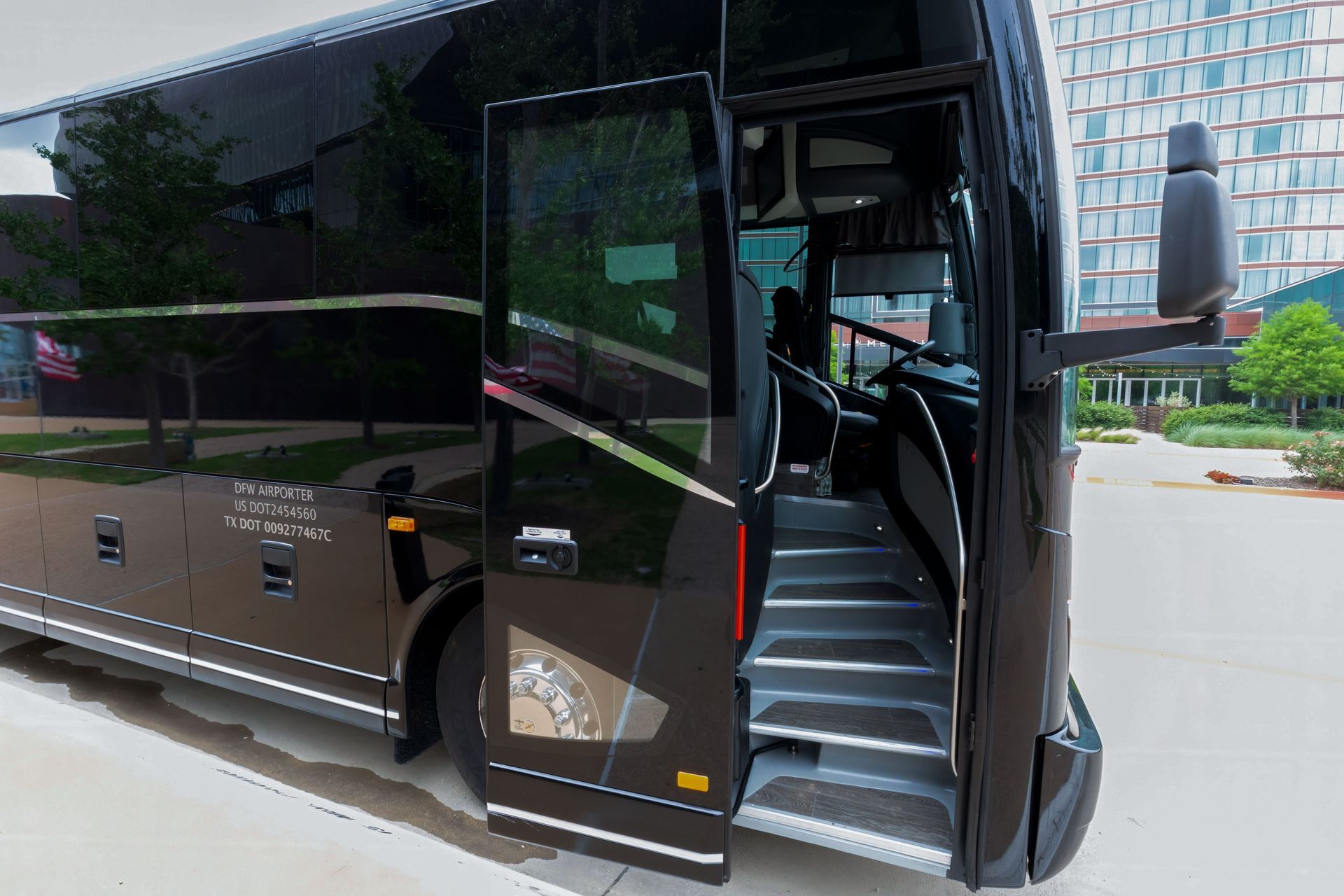 A black double decker bus with the door open