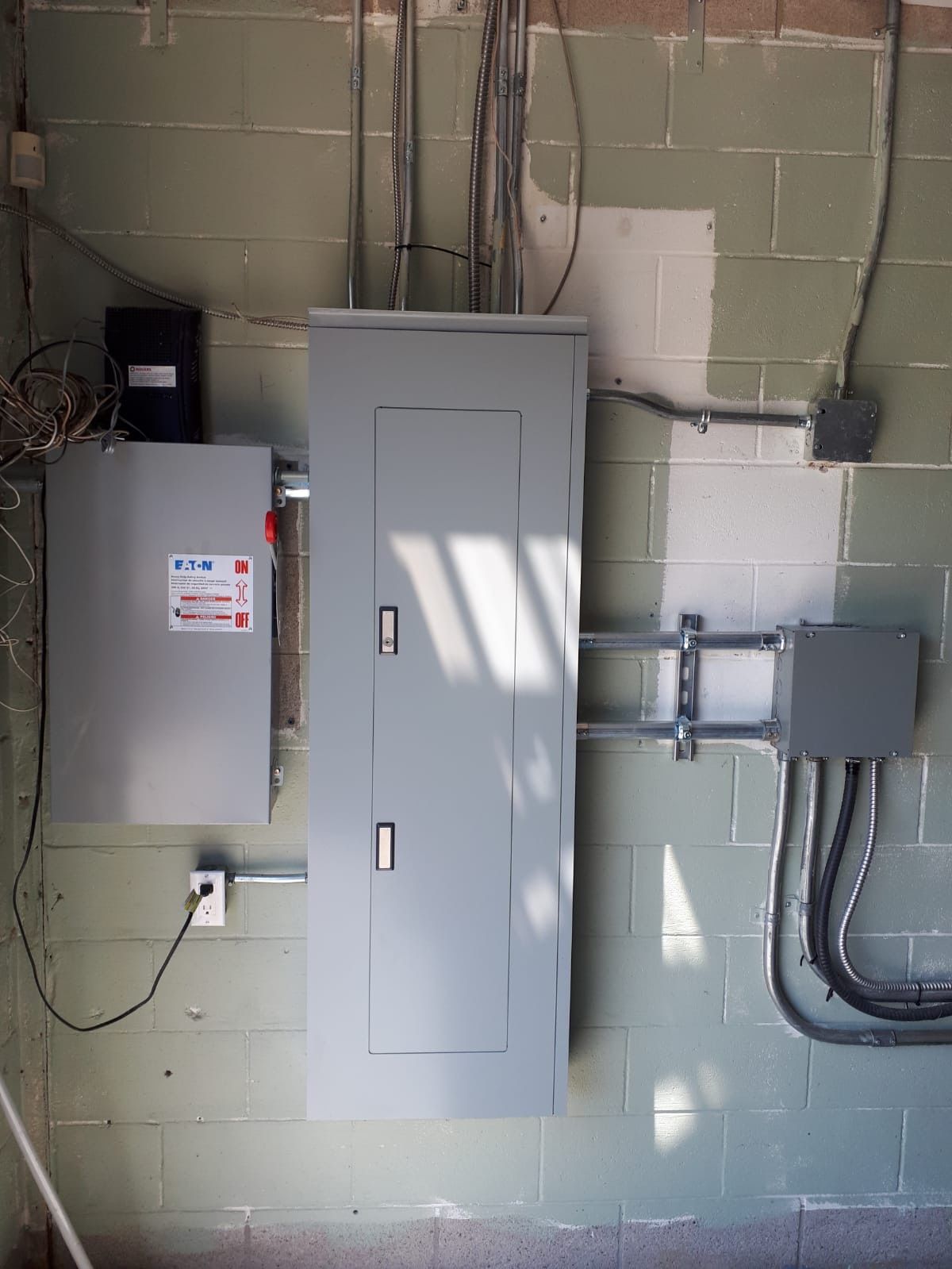 White Generac home generator with orange logo, sitting outside.