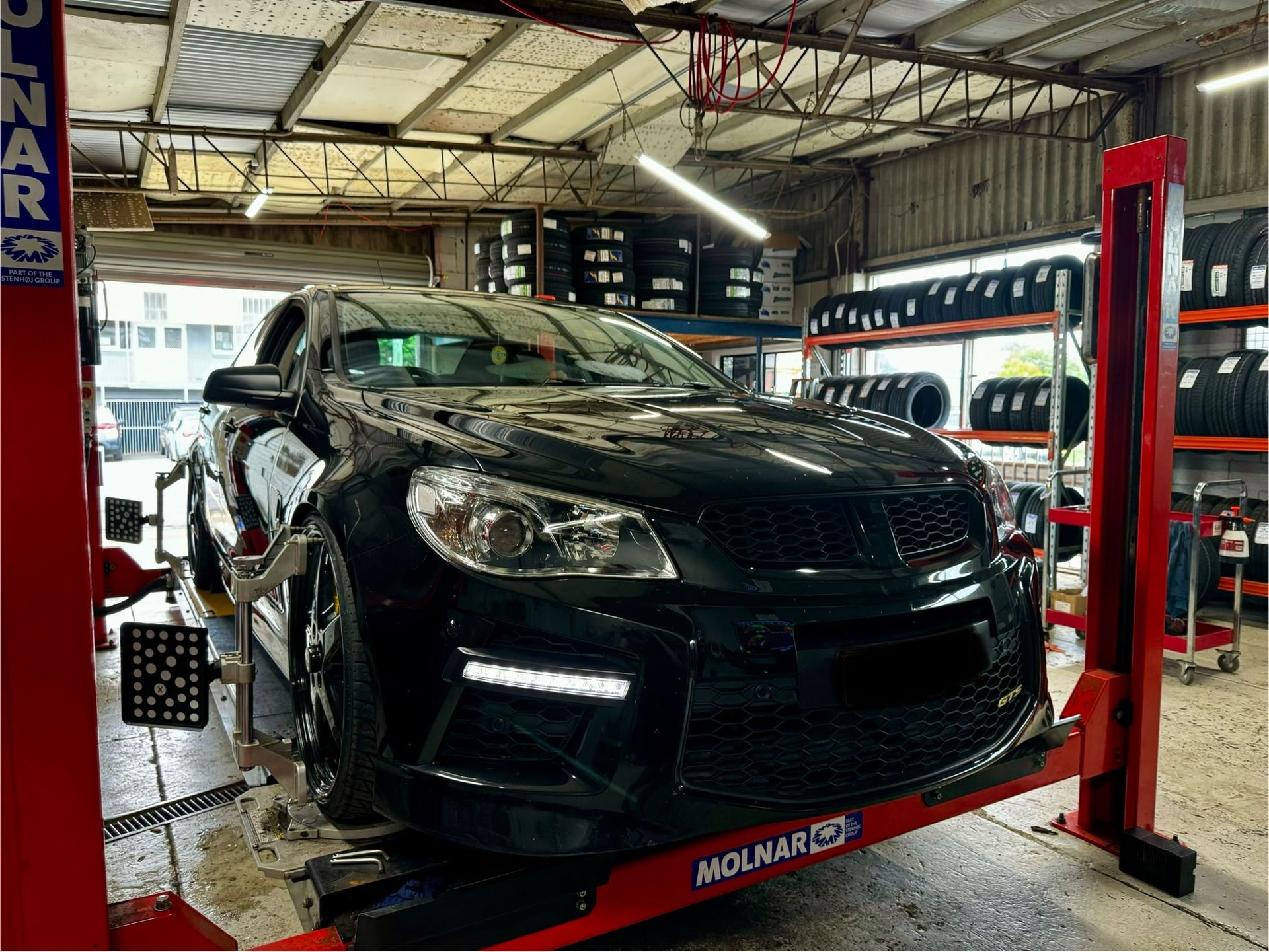 A Car on A Lift in A Garage — Jakes Tyres in South Murwillumbah, NSW